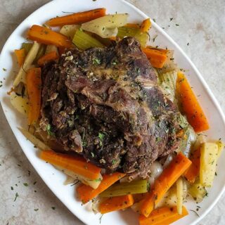 Keto post roast recipe on a white dish on a marble surface.