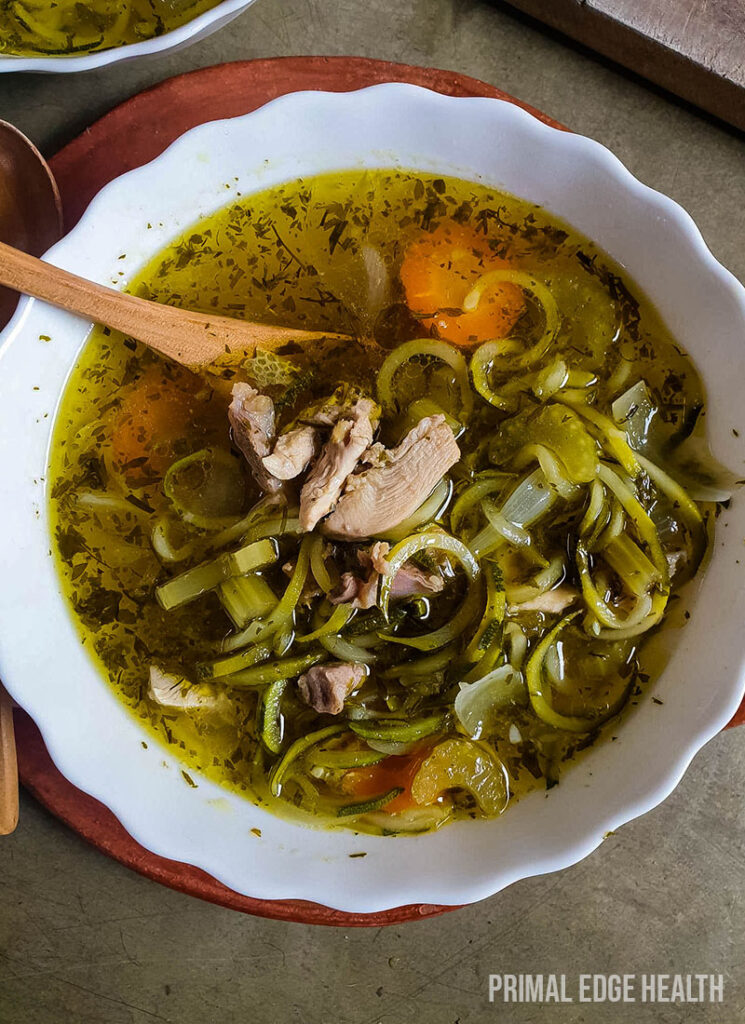 Keto chicken noodle soup in a white bowl.