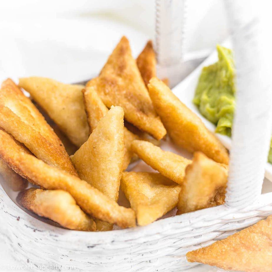 Tortilla chips in a clean white basket.