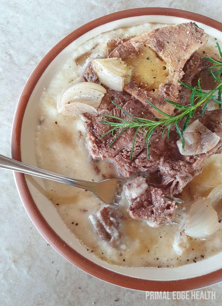 Beef shank slow cooker in a bowl served with a fork.