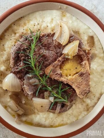 Beef shank slow cooker in a white and brown bowl.