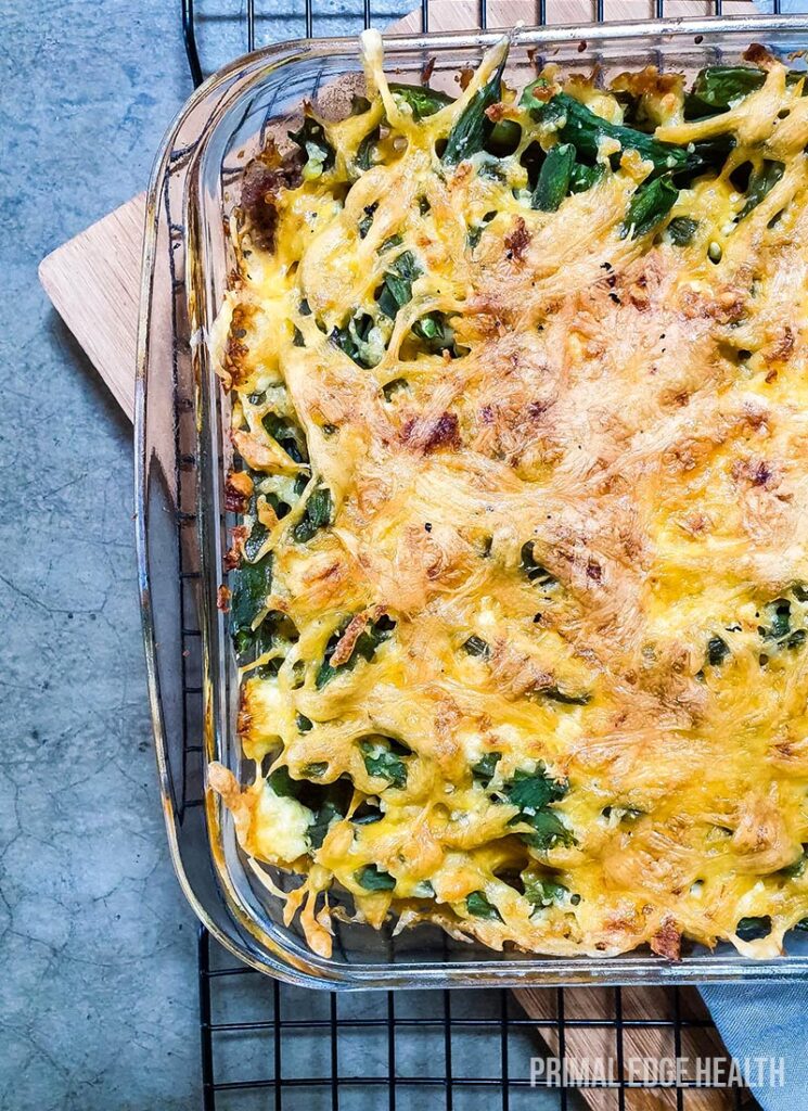 Green bean hamburger casserole in a square glass dish.
