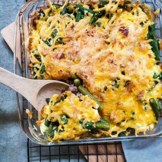 Green bean hamburger casserole served in a glass dish.