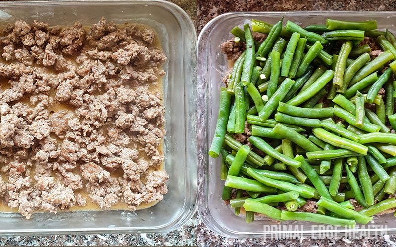A clear dish containing meat and the other string beans.