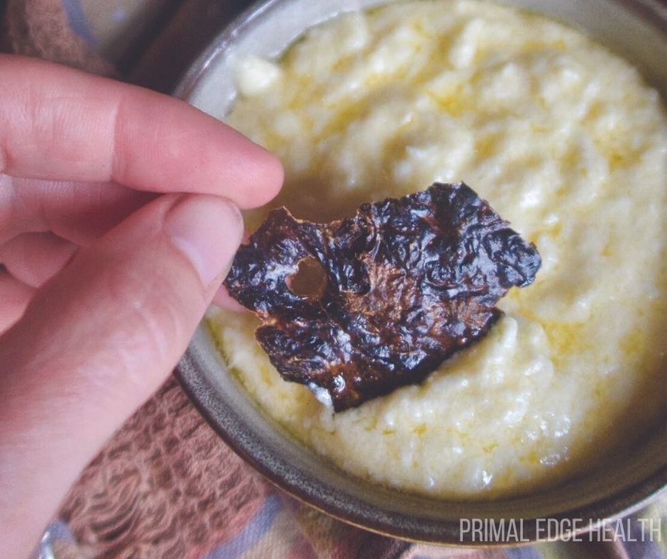 A liver chip being dipped into a yellow sauce.