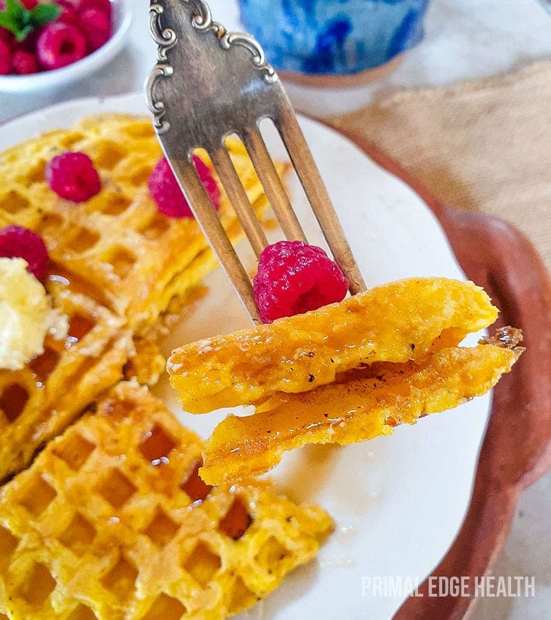 Keto waffles on white plate with a fork.