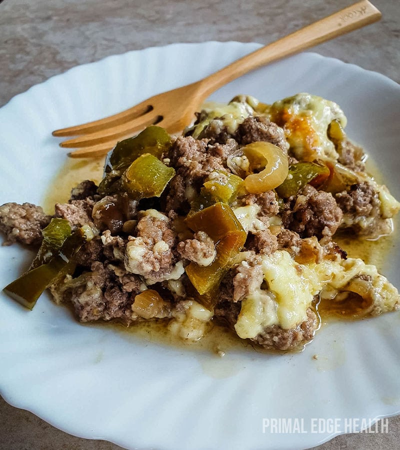 Philly cheesesteak casserole on a plate on marble surface.
