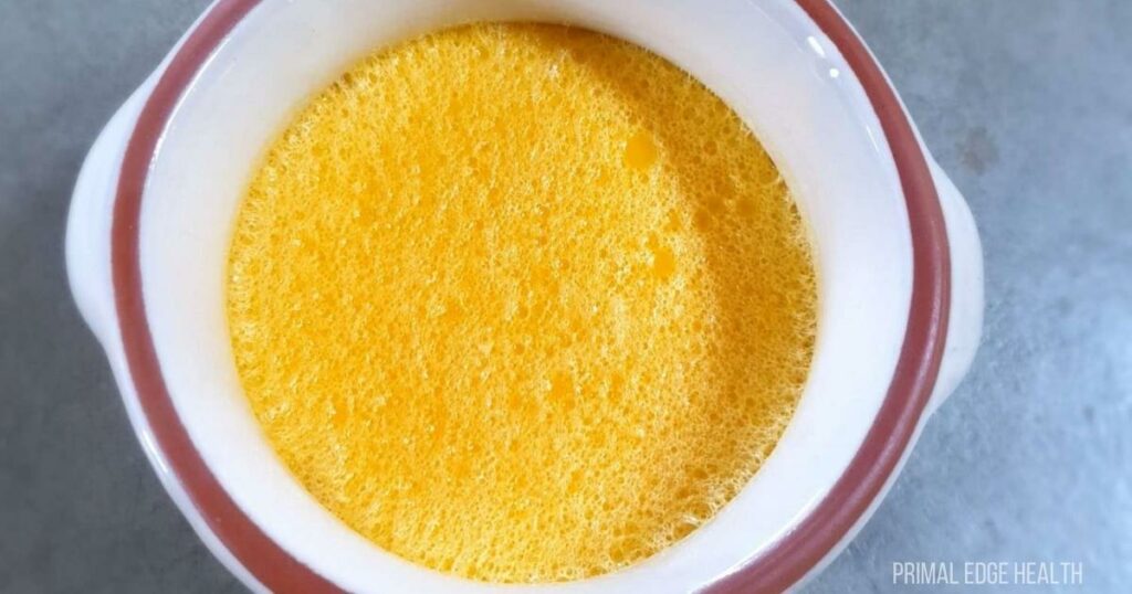 No bake custard in a white cup.