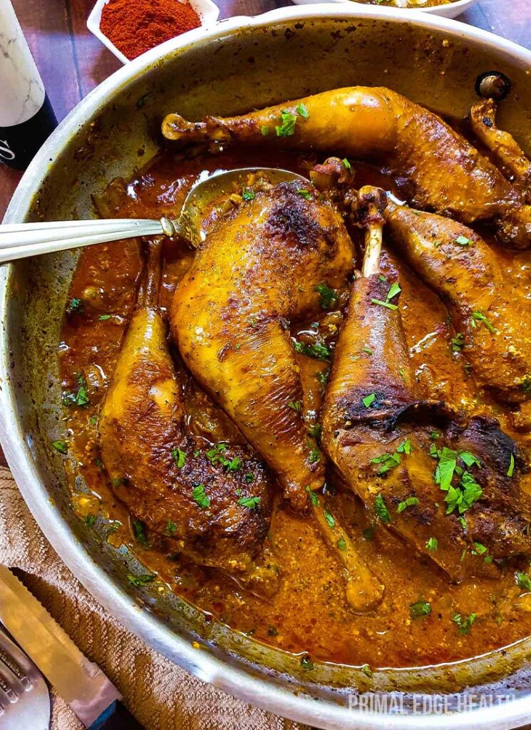 A skillet of keto chicken paprikash garnished with herbs.