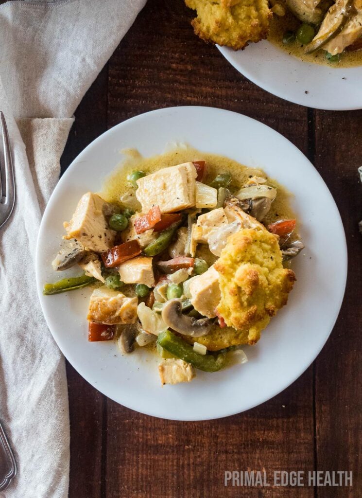 A plate of keto chicken ala king served with fork and white cloth.