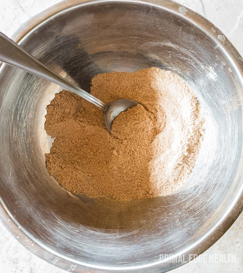 A mixing bowl containing brown dry ingredients.