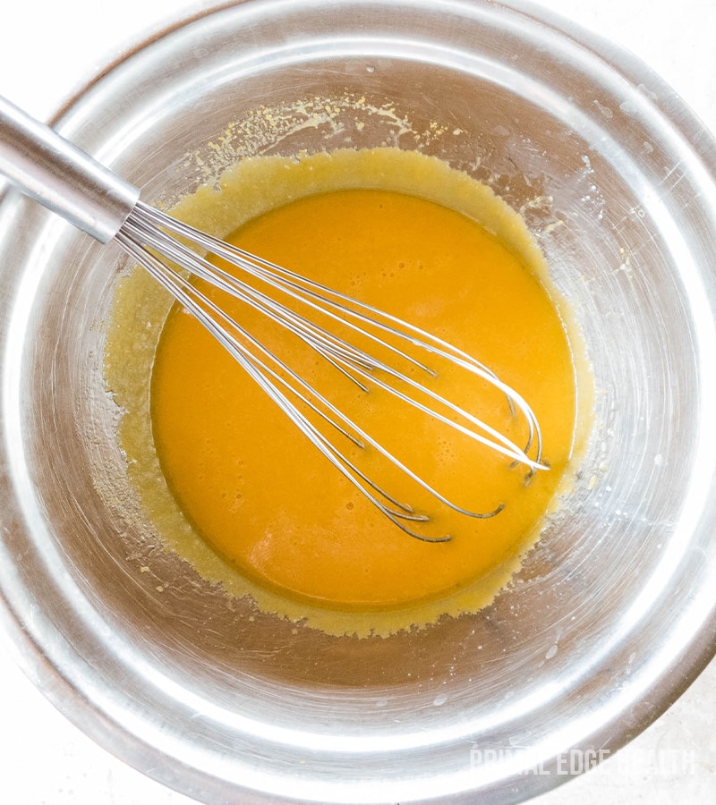 Whisk in a steel bowl mixing egg yolks.