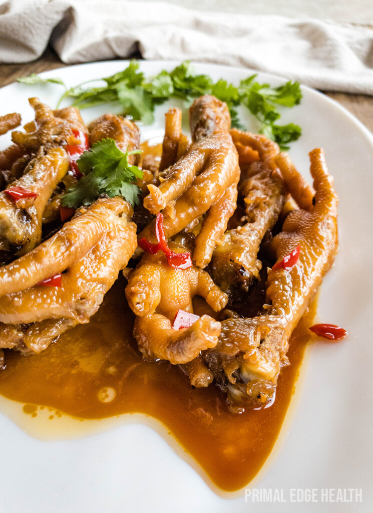 Chicken feet adobo served with garnish.