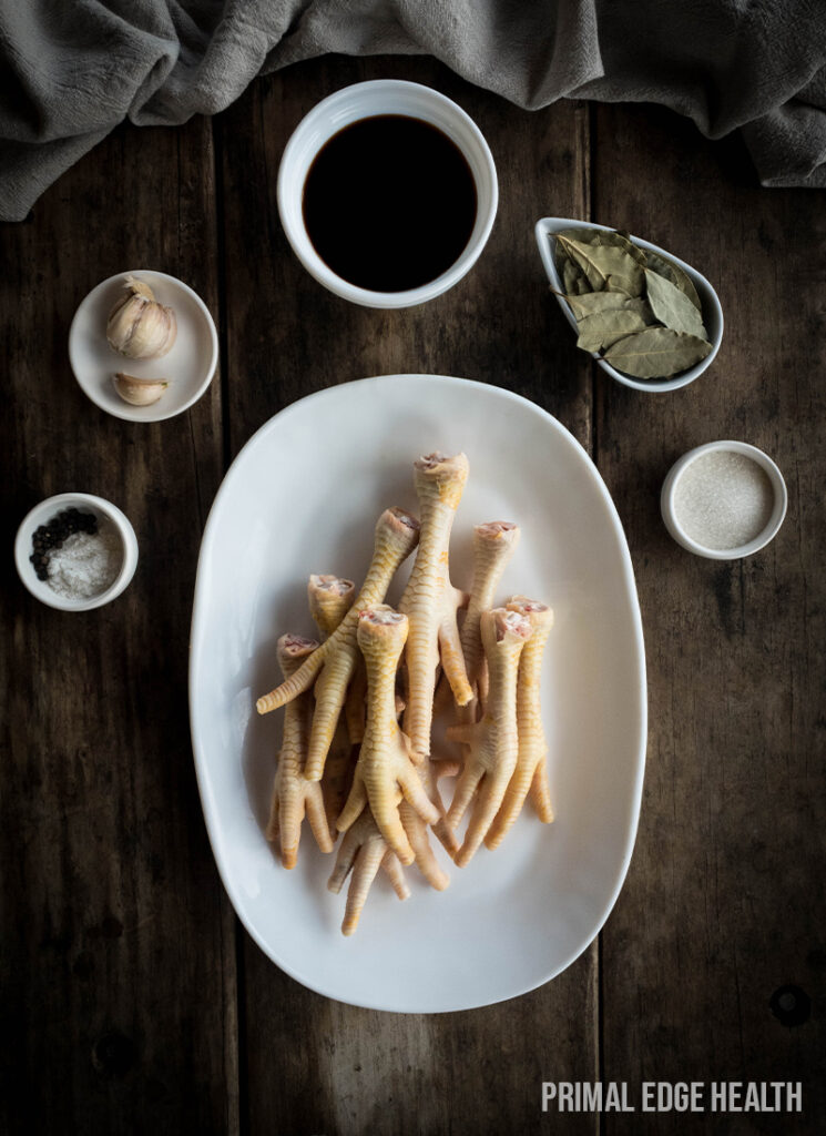 Adidas chicken feet ingredients on wooden table.