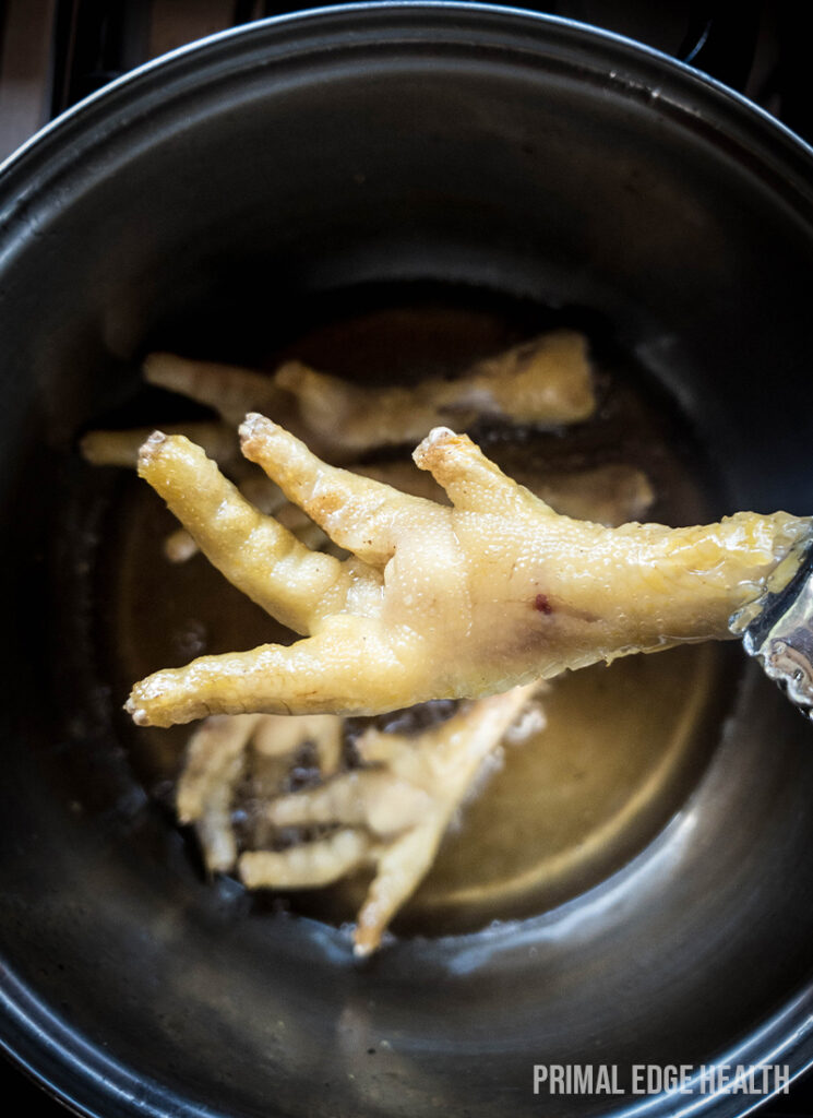 Browning chicken feet for the recipe.