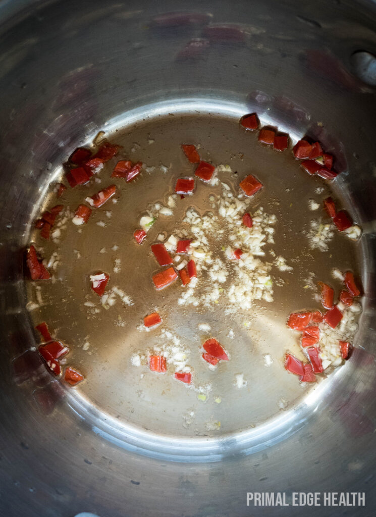 Sauteing onion in a skillet for the Adobong adidas dish.