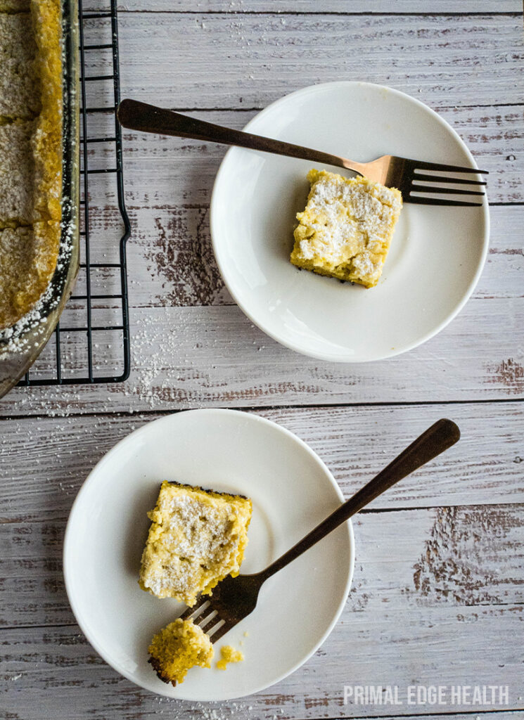 Two plates with slices of keto gooey butter cake and forks.