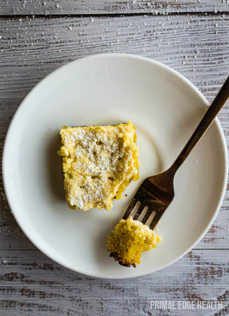 A piece of keto gooey butter cake with a bite taken out.