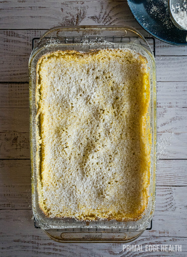 Butter cake in a glass dish on a wooden table.