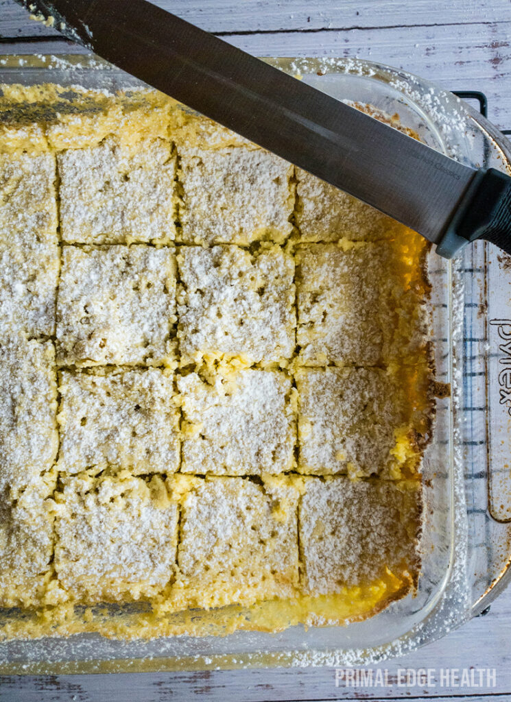 A glass baking dish of sliced gooey butter cake.