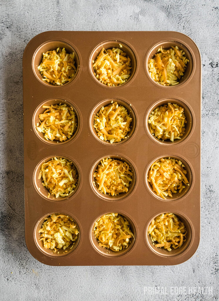 A muffin tin filled with mixture, ready for baking.