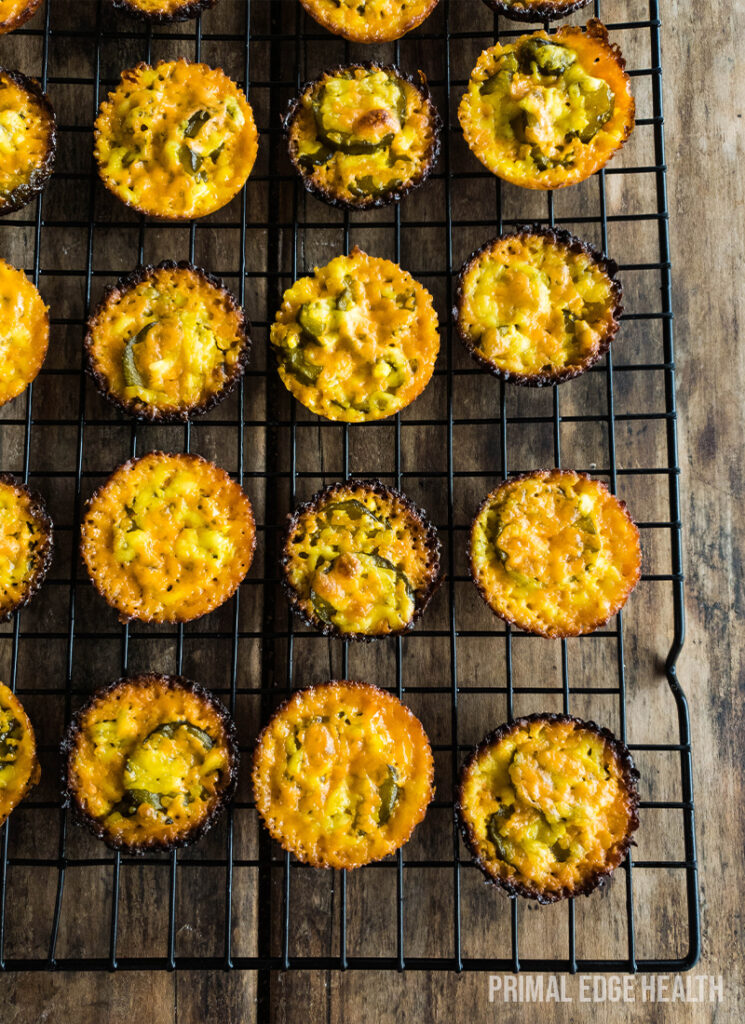 Golden brown muffins cooling on a wire rack.