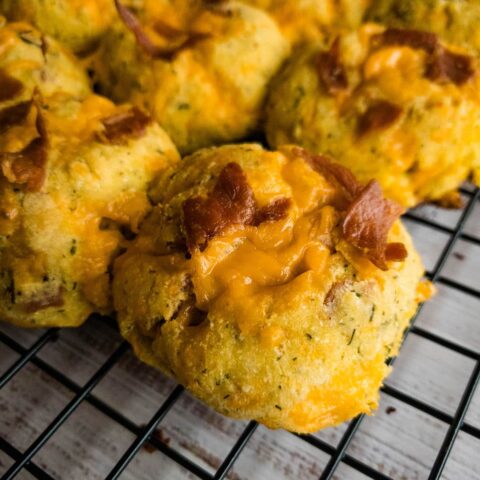 A bunch of keto crack biscuits on a wire rack.