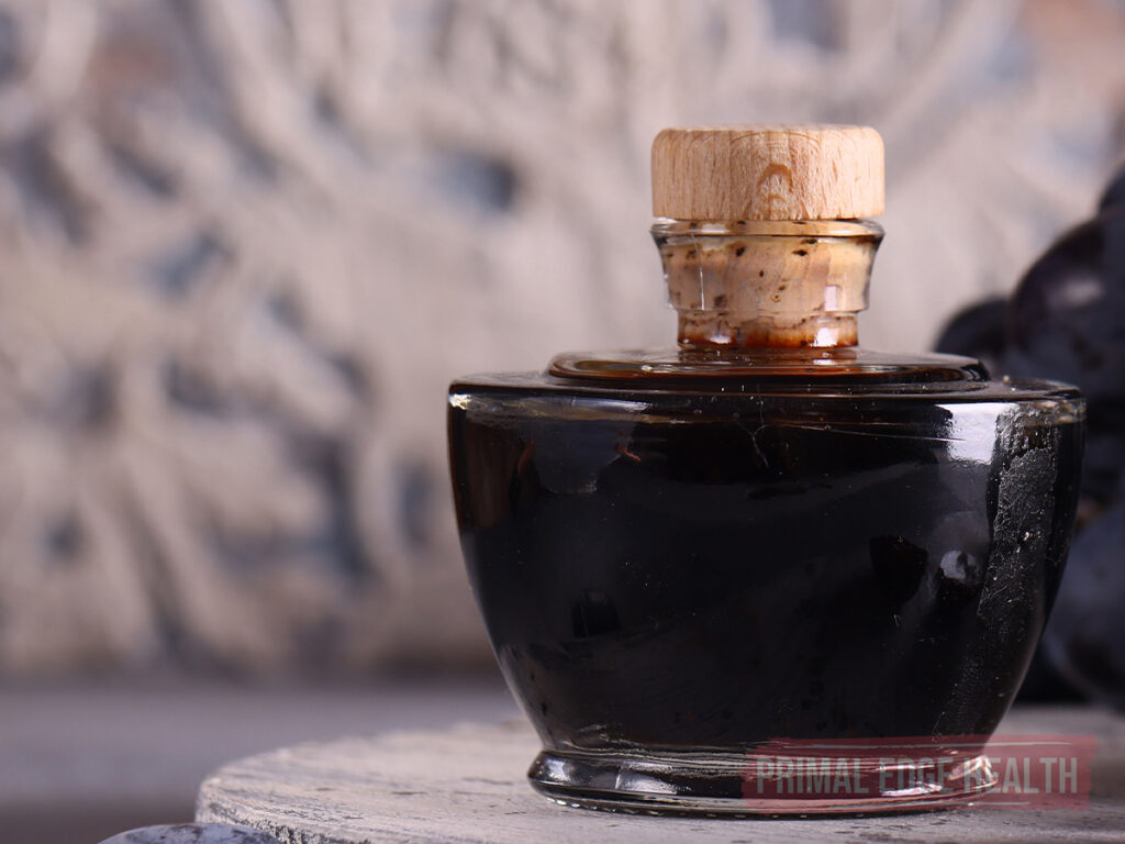 Small glass bottle of balsamic glaze with cork stopper.