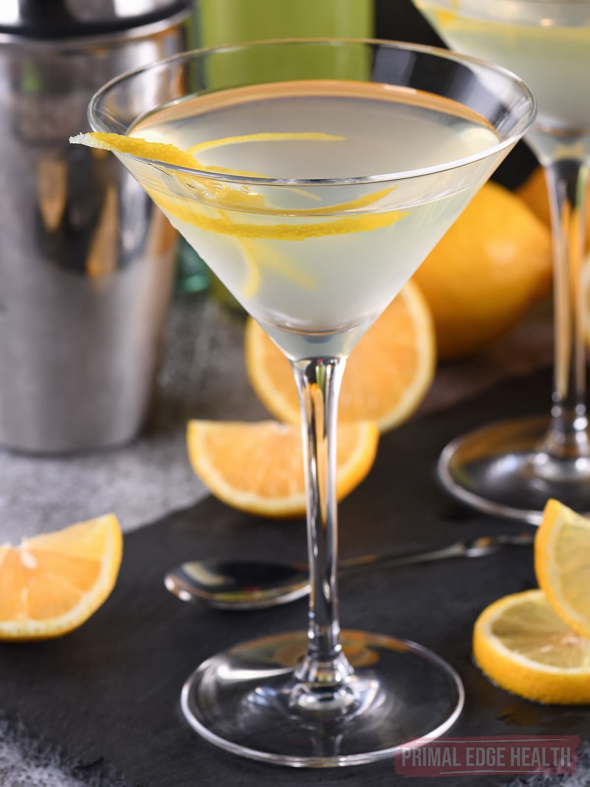 Keto vodka lemon drop martini in a glass with lemon twist.