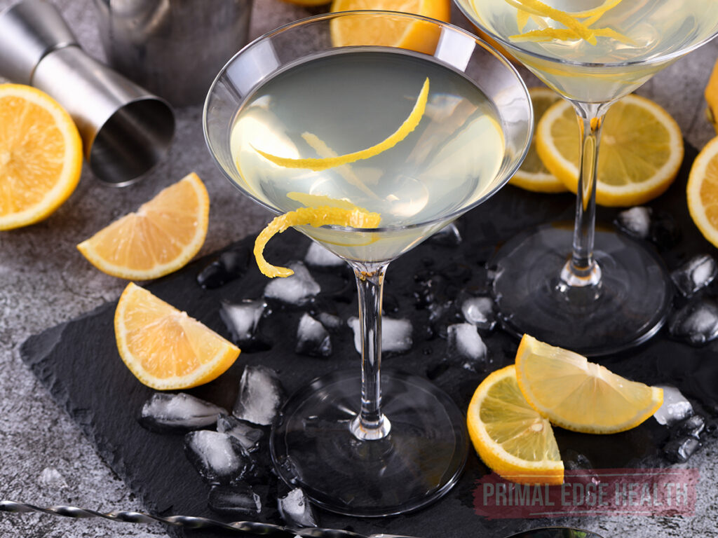 low calorie lemon drop martini in a martini glass with lemon twist and a second glass in the background