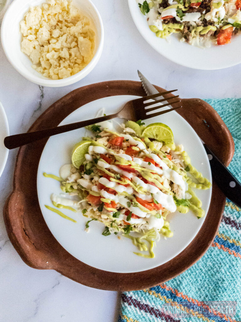 keto chicken tostada on a plate with cheese crumbles