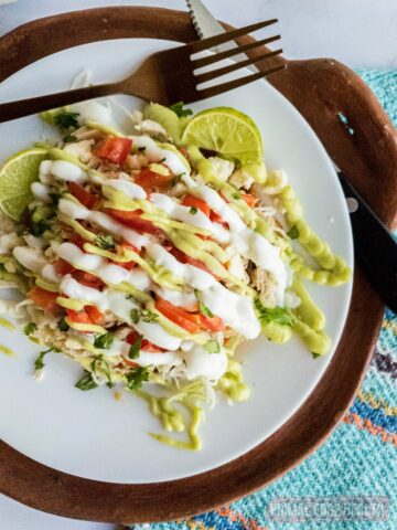 Tostada plated with knife and fork alongside.