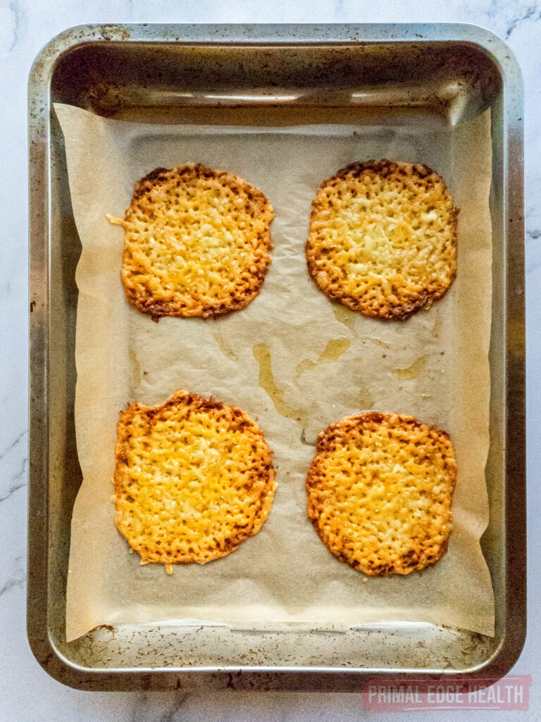 Four tostada shells on baking sheet.