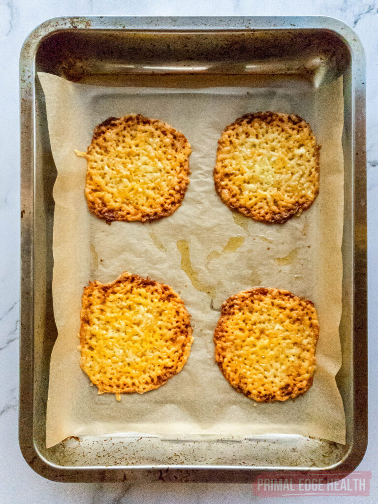 four cheese tostada shells on baking sheet