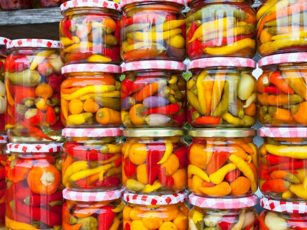 Stacked glass containers of peppers.