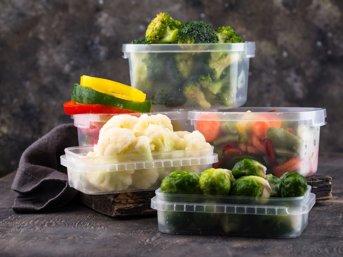 Plastic food storage containers with veggies.
