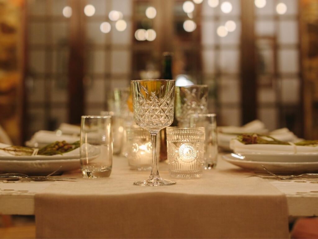 Fancy table setting with a wine glass and plates.