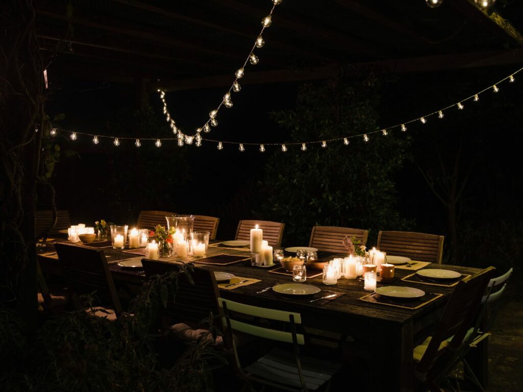 Table setting at night with plates and candles.