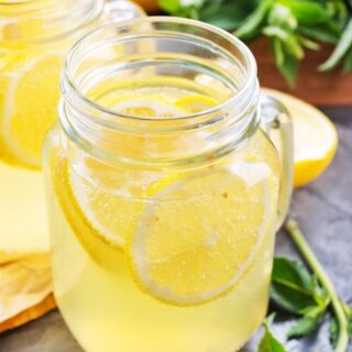 Glass of lemonade with slice of lemons.