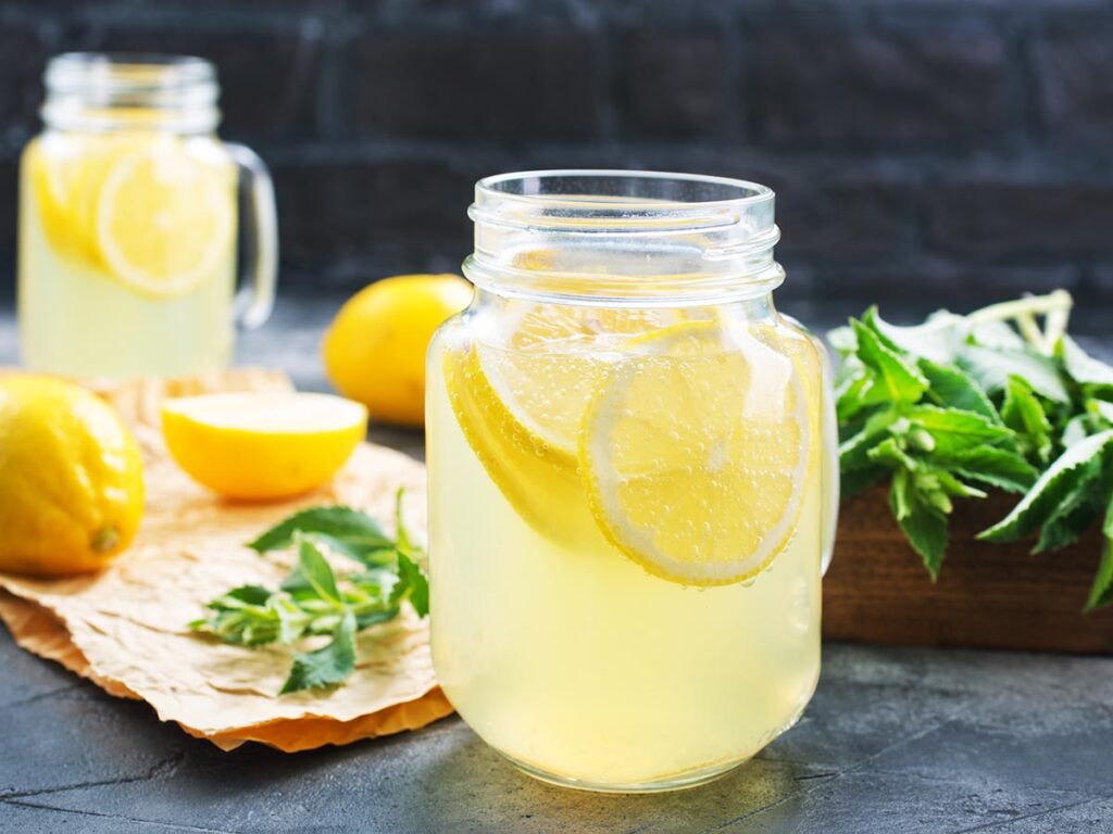 keto lemonade in glass with mint in background