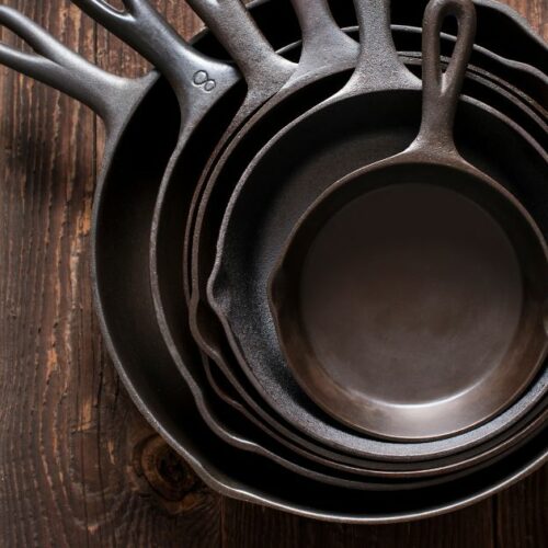 stack of clean cast iron skillets