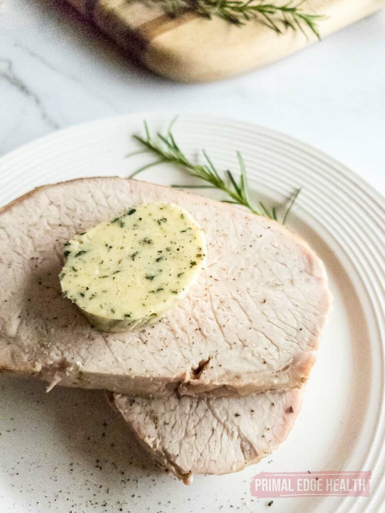 A slice of butter on top of meat.