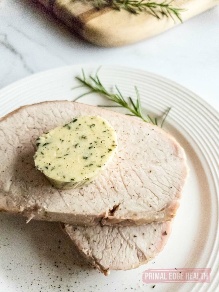 rosemary compound butter slice on top of meat