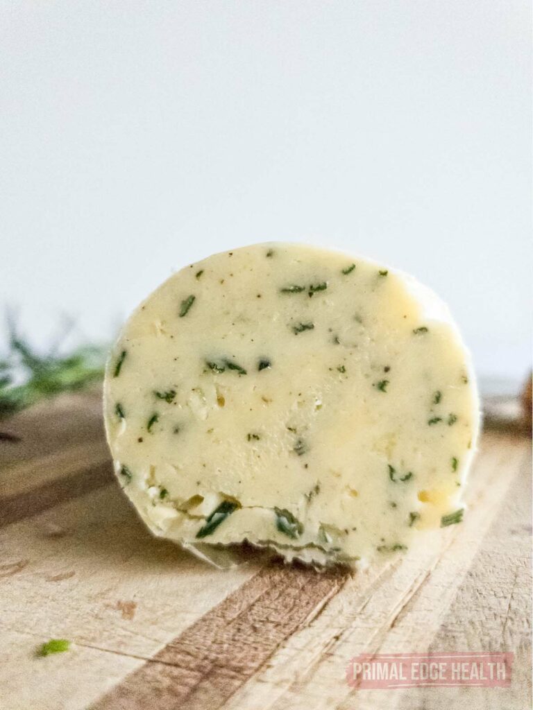 Close up view of a roll of butter, cut in half.