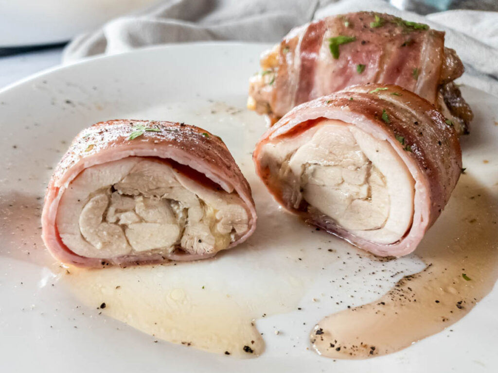 Served bacon wrapped chicken thighs, cut open in half.