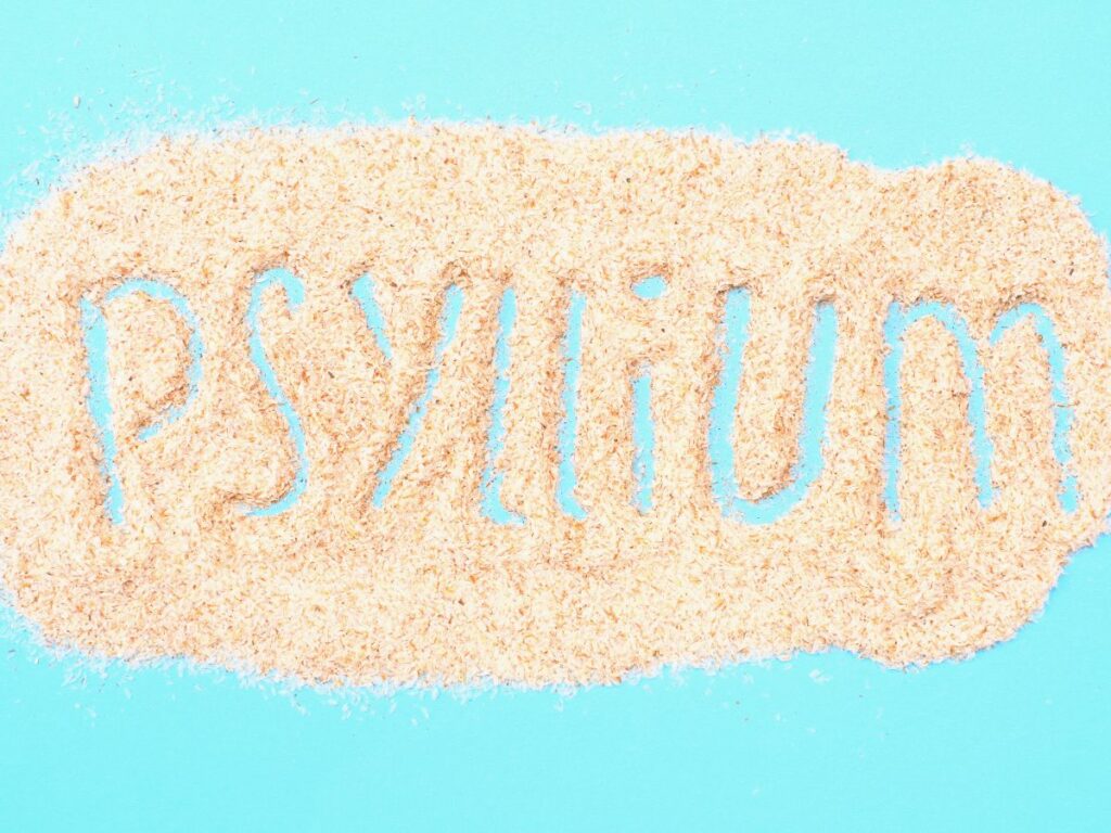 Psyllium written in psyllium husk on bright blue background.