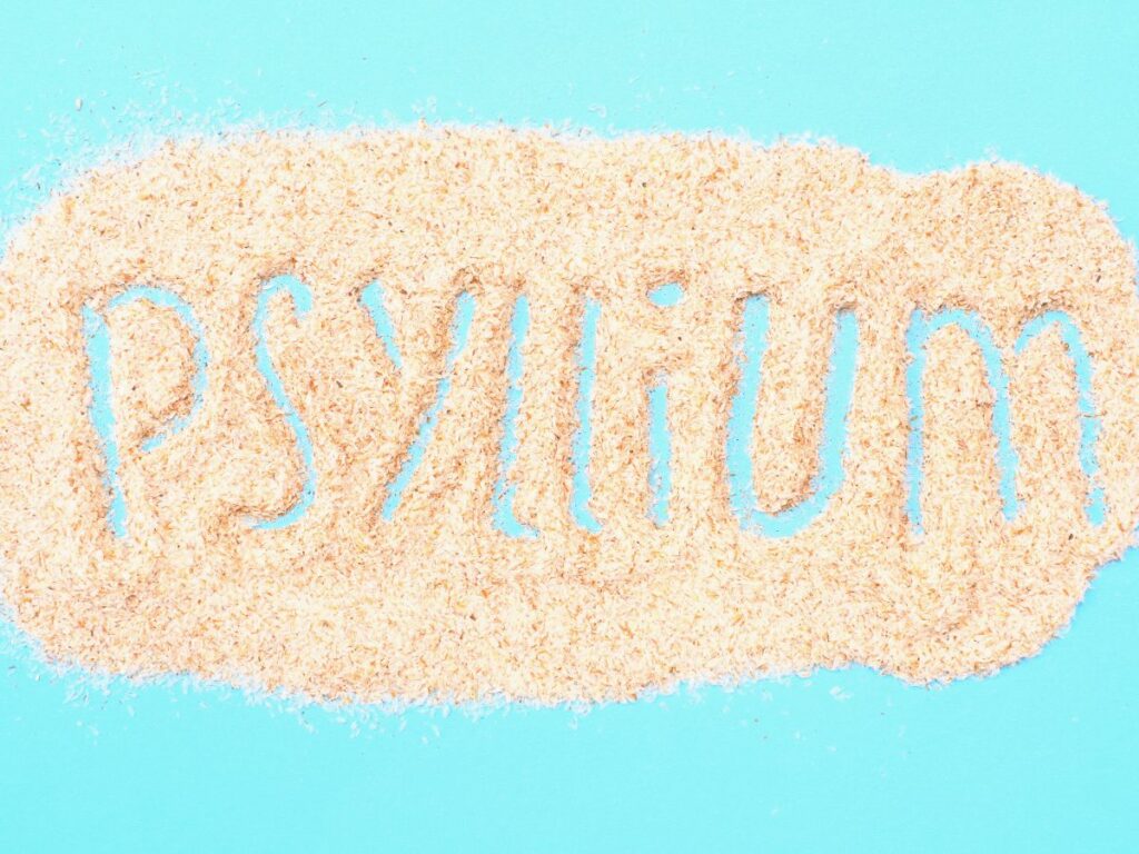 Psyllium written in psyllium husk on bright blue background.