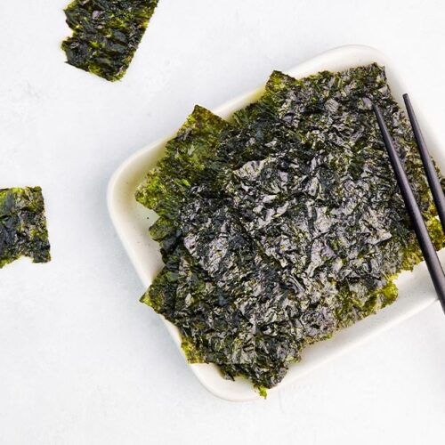 toasted nori in a white bowl with chopsticks