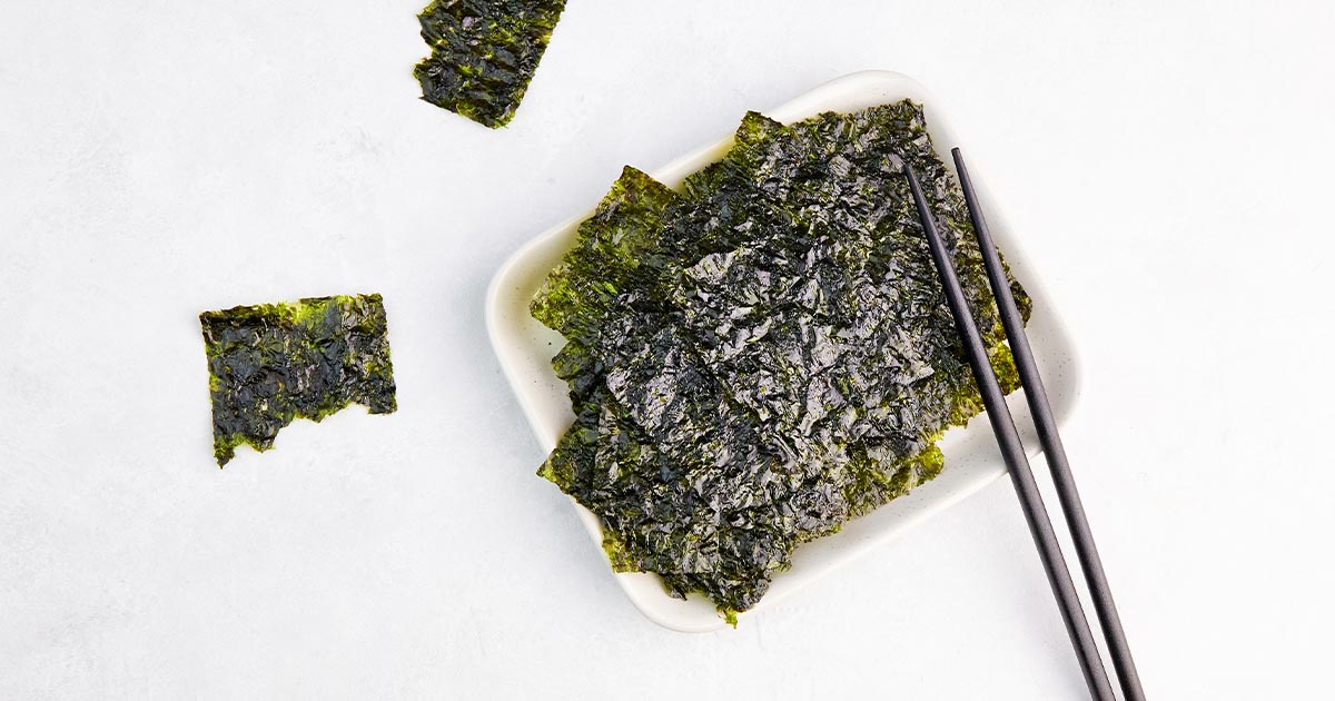 toasted nori in a white bowl with chopsticks
