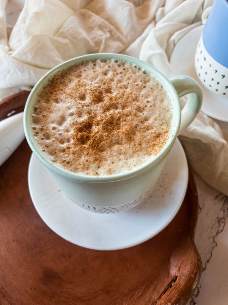 Cinnamon dusted frothed milk ashwagandha coffee late.